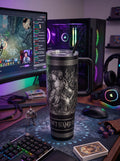Engraved black 40oz handle tumbler with a warrior in flames on a gaming desk with RGB lights