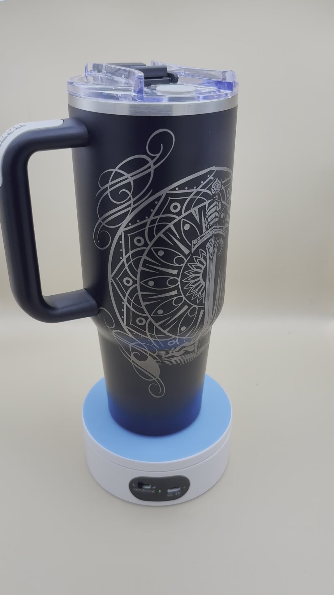 Real video of the engraved knight tumbler, a kneeling knight with sword and shield laser engraved on black steel.